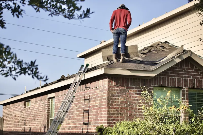 Professional roofer working on a residential roof in Longbranch